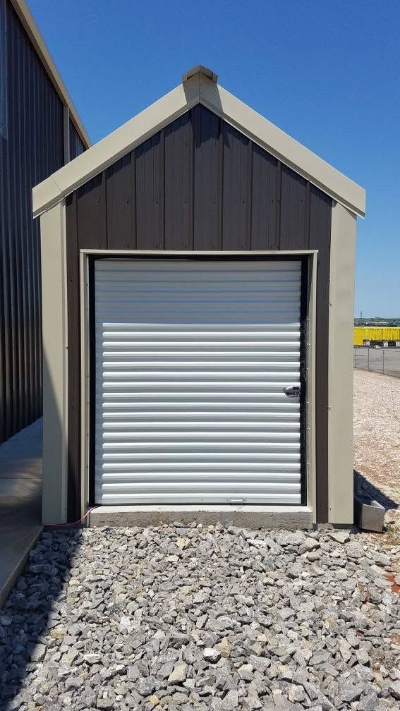 White roll-up door on a small metal shed
