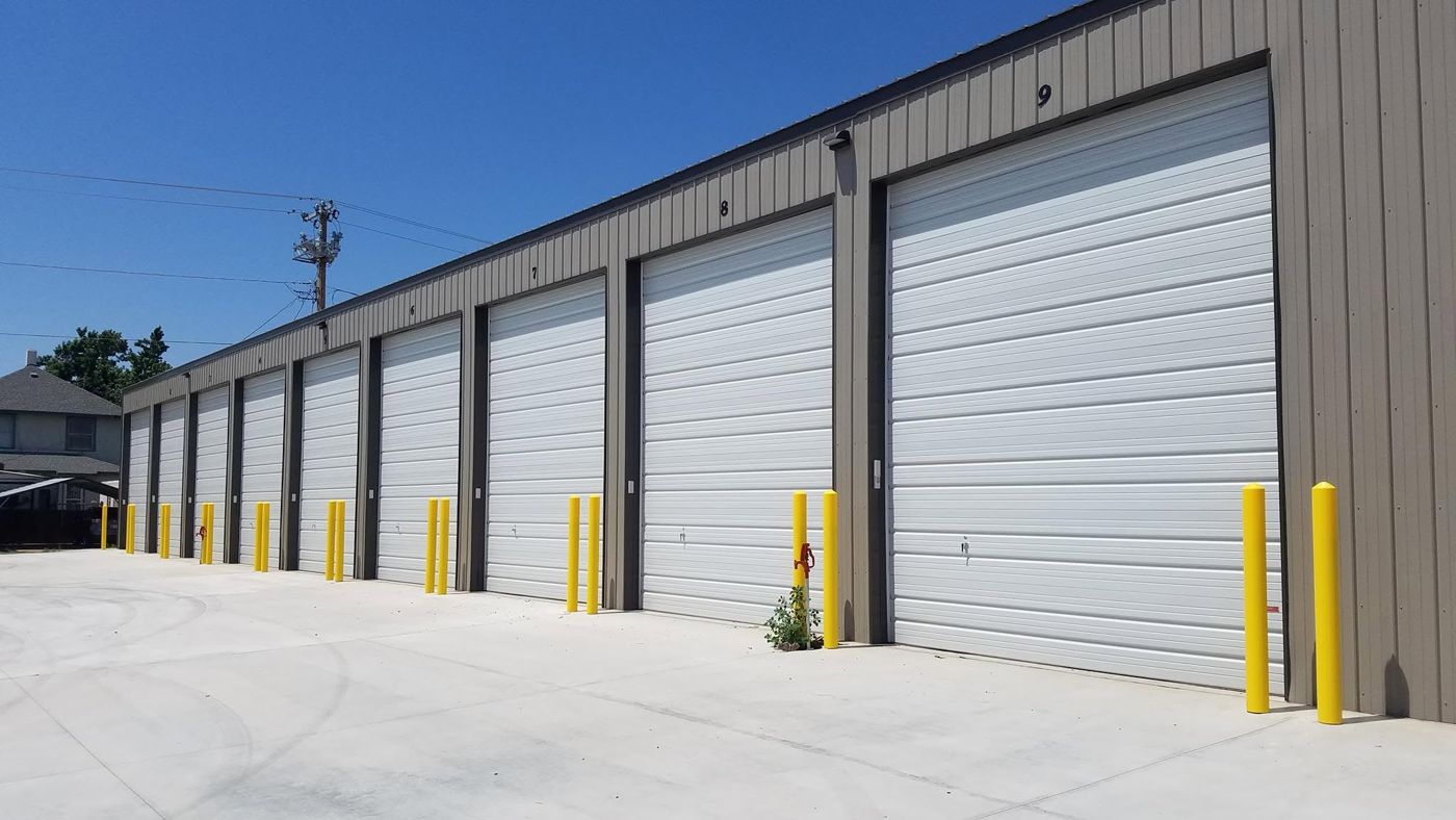 Row of white commercial doors on a storage building