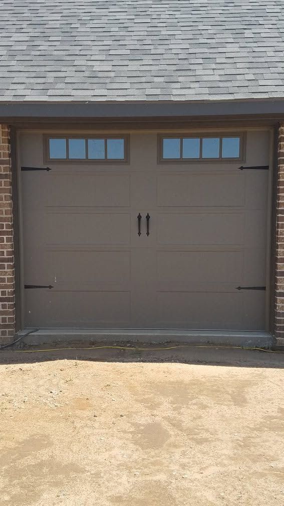Tan single garage door with window lites and black hardware
